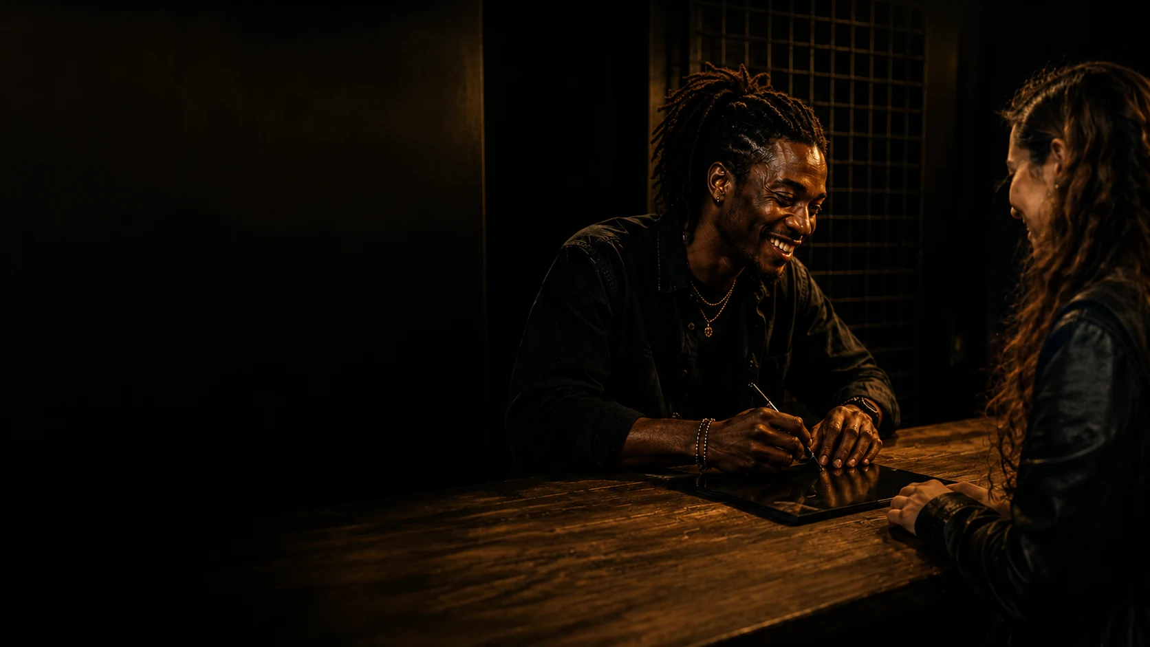 A smiling artist signs a record for a fan.